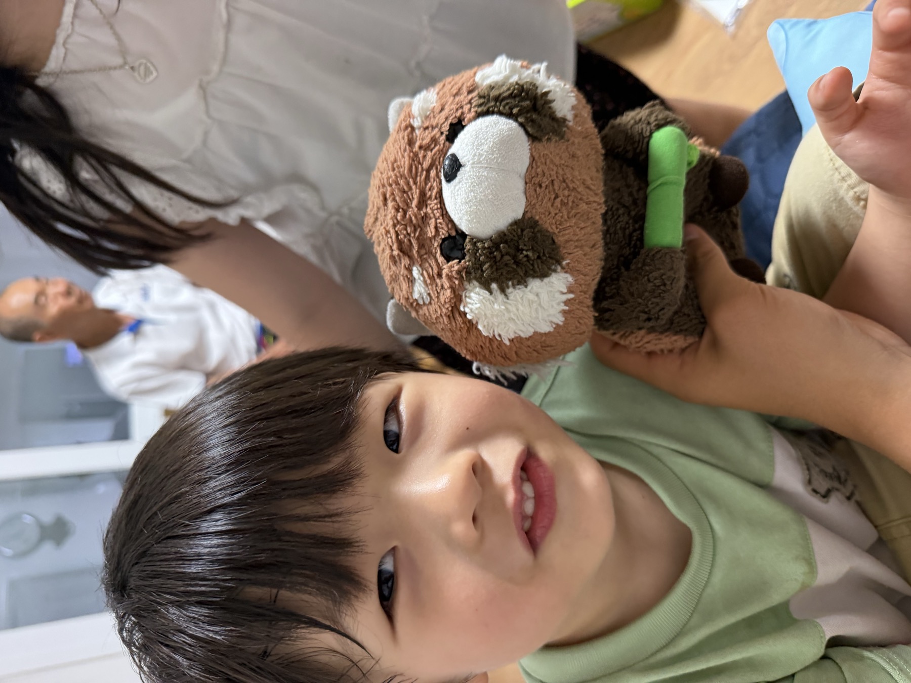 a child holding bamboo the stuffed animal
